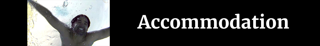 A photo of a white man swimming underwater on a black banner with the text "Accommodation"