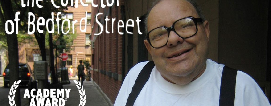 Poster for "the Collector of Bedford Street". A smiling man with big glasses looks at the camera, in a white tshirt and black suspenders.
